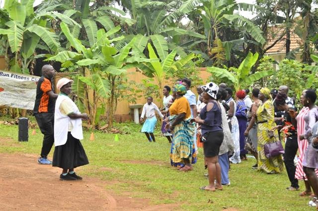 Community members walk together along a village path during an RDAF health walk.