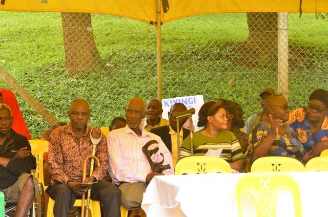 Community members seated under a tent during an RDAF event.