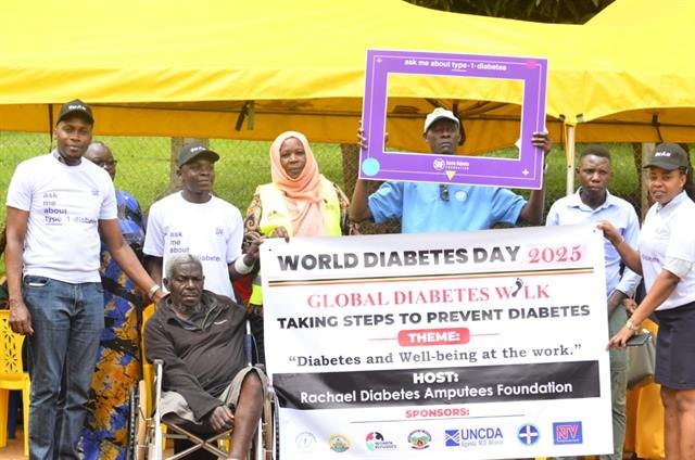 Participants hold an RDAF World Diabetes Day banner under an event tent.