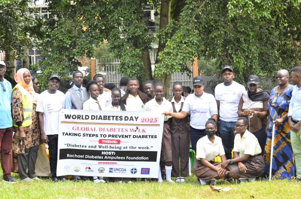 Participants and partners stand together behind an RDAF World Diabetes Day banner listing sponsoring organisations.